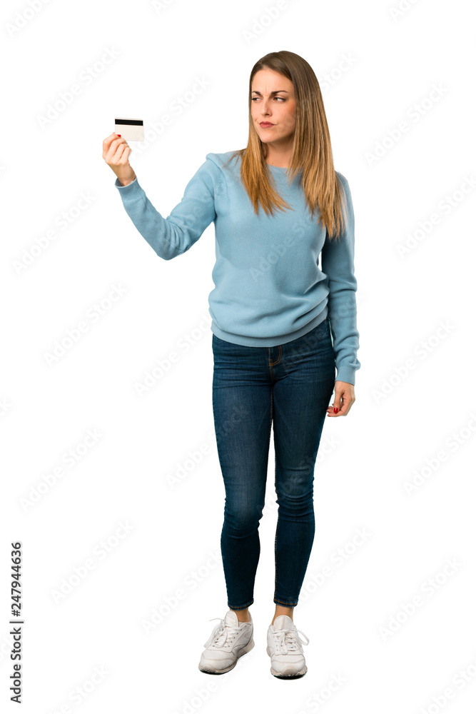 Full body of Blonde woman with blue shirt taking a credit card without money on white background Full body of Blonde woman with blue shirt taking a credit card without money on white background
