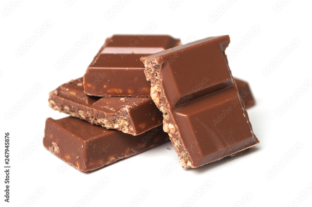 closeup of milk puffed rice chocolate blocks on white background closeup of milk puffed rice chocolate blocks on white background
