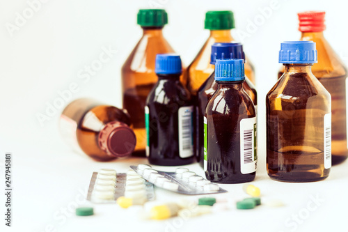 Medicine bottles, pills or capsules blister pack on white background with copy space for text, retro concept closeup.