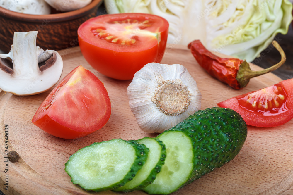 Fresh vegetables on a cutting board with a knife Fresh vegetables on a cutting board with a knife