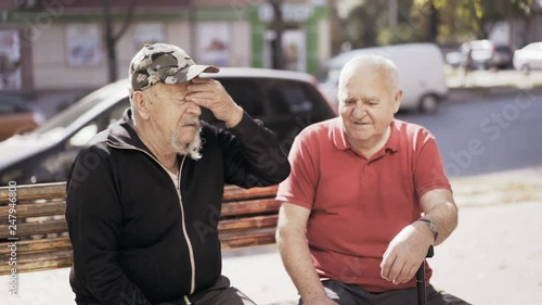 Portrait of old friends talk sadly with nostalgia outdoor. photo