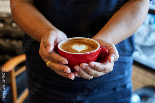 cup of latte coffee in woman hand