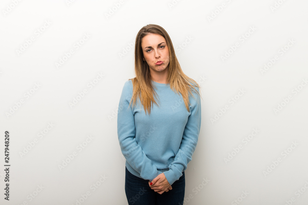 Blonde woman on isolated white background with sad and depressed expression Blonde woman on isolated white background with sad and depressed expression