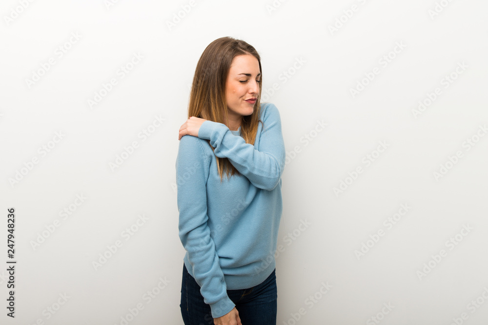 Blonde woman on isolated white background suffering from pain in shoulder for having made an effort