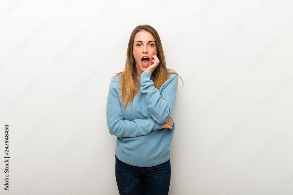 Blonde woman on isolated white background surprised and shocked while looking right Blonde woman on isolated white background surprised and shocked while looking right
