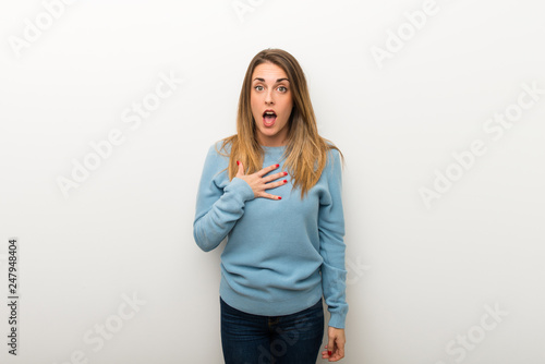 Blonde woman on isolated white background surprised and shocked while looking right © luismolinero