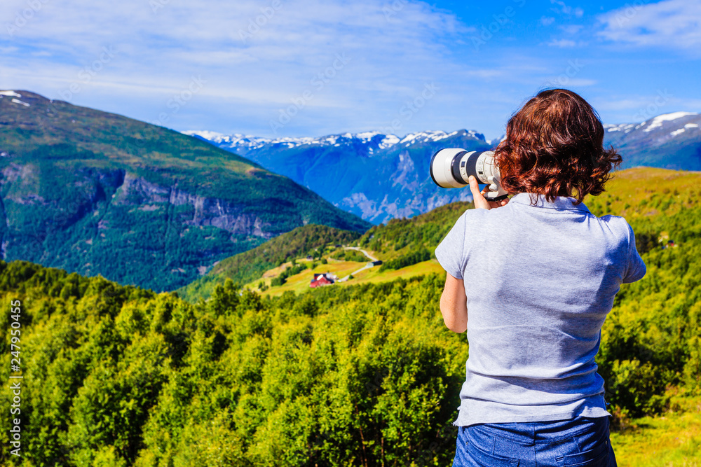 Tourist taking photo in norwegian nature