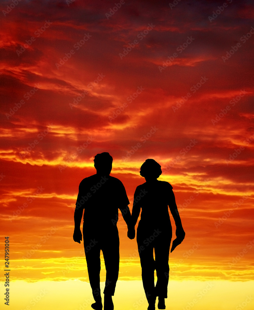 senior couple walking at sunset