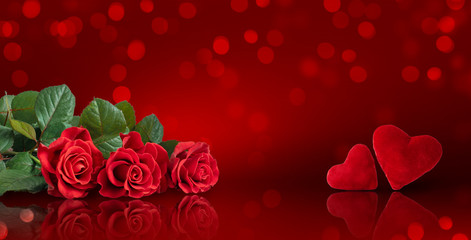 Decorative card for Valentines Day or wedding with roses bouquet and two hearts on red background with glowing bokeh