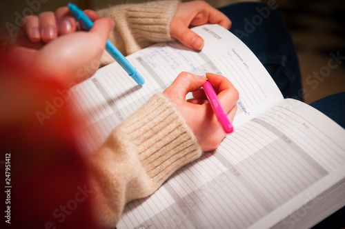 Woman hands with notepad and pens. Business planning  notepad and hands.