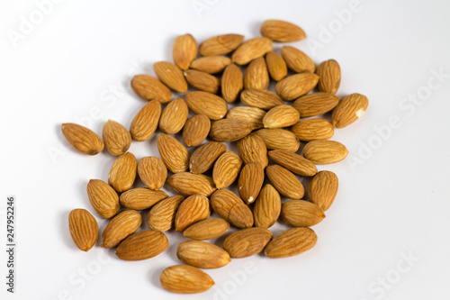 handful of almonds on white background