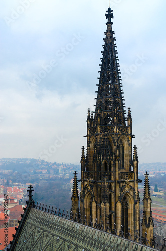 Neogothic stone tower of famous St. Vitus Cathedral on background of city, Prague, Czech Republic