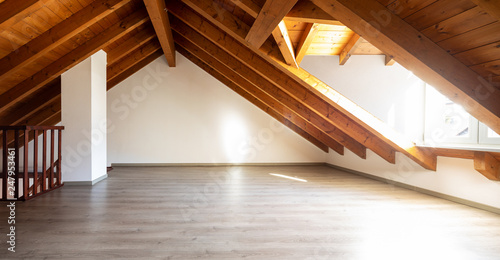 Bilde på lerret Bright attic with wooden beams and parquet