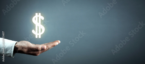 Man hand holding dollar sign. photo