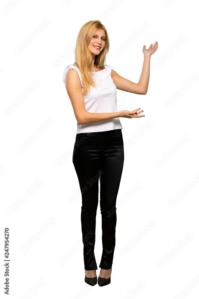 Young blonde woman extending hands to the side for inviting to come over isolated white background Young blonde woman extending hands to the side for inviting to come over isolated white background