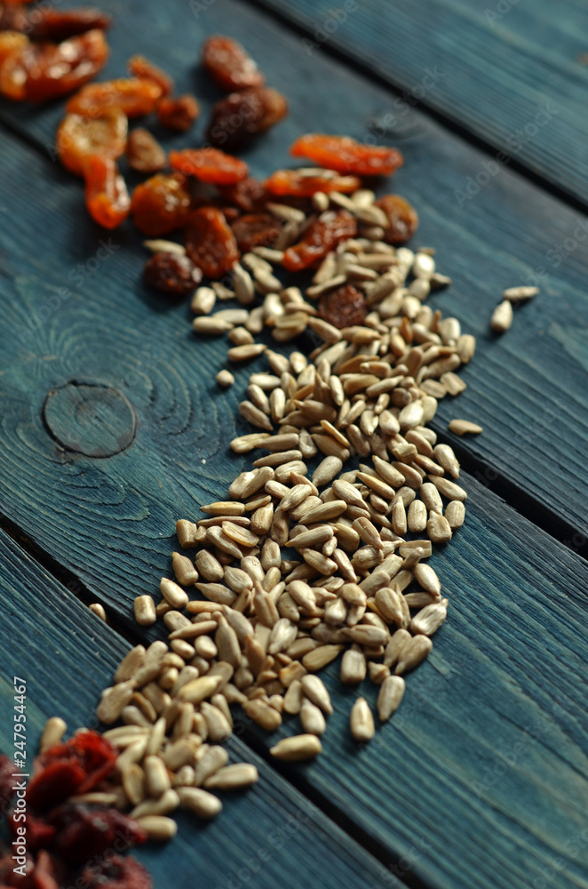 Sunflower seeds on a blue wooden background Sunflower seeds on a blue wooden background