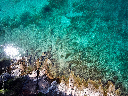 top view of rocky shore crystal clear Adriatic Sea, drone shot