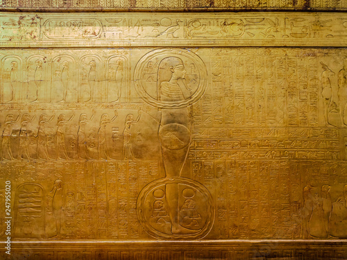 Drawings and hieroglyphs on a gilded wooden box in which the Tutankhamun sarcophagus was found. Egypt Cairo photo