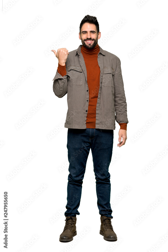 Full-length shot of Handsome man with beard pointing to the side to present a product on isolated white background Full-length shot of Handsome man with beard pointing to the side to present a product on isolated white background