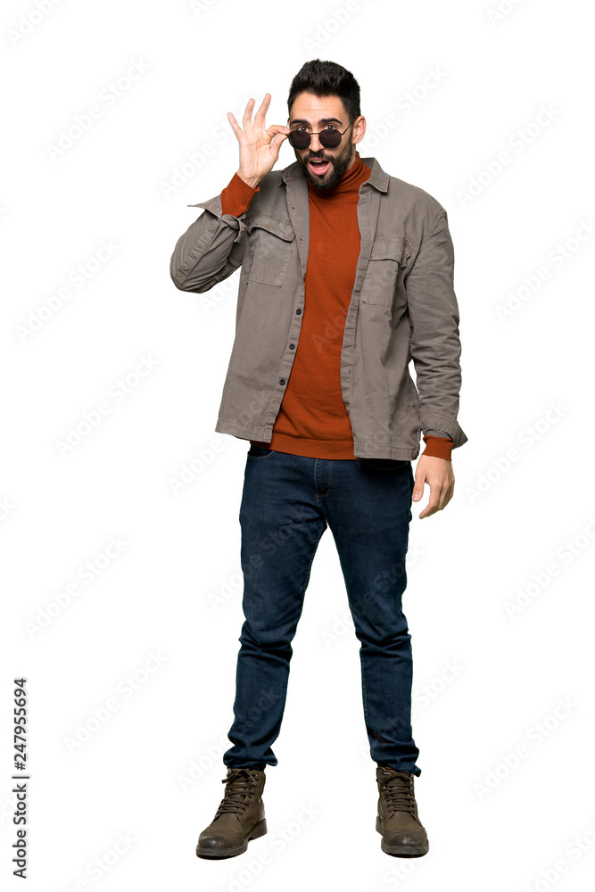 Full-length shot of Handsome man with beard with glasses and surprised on isolated white background Full-length shot of Handsome man with beard with glasses and surprised on isolated white background