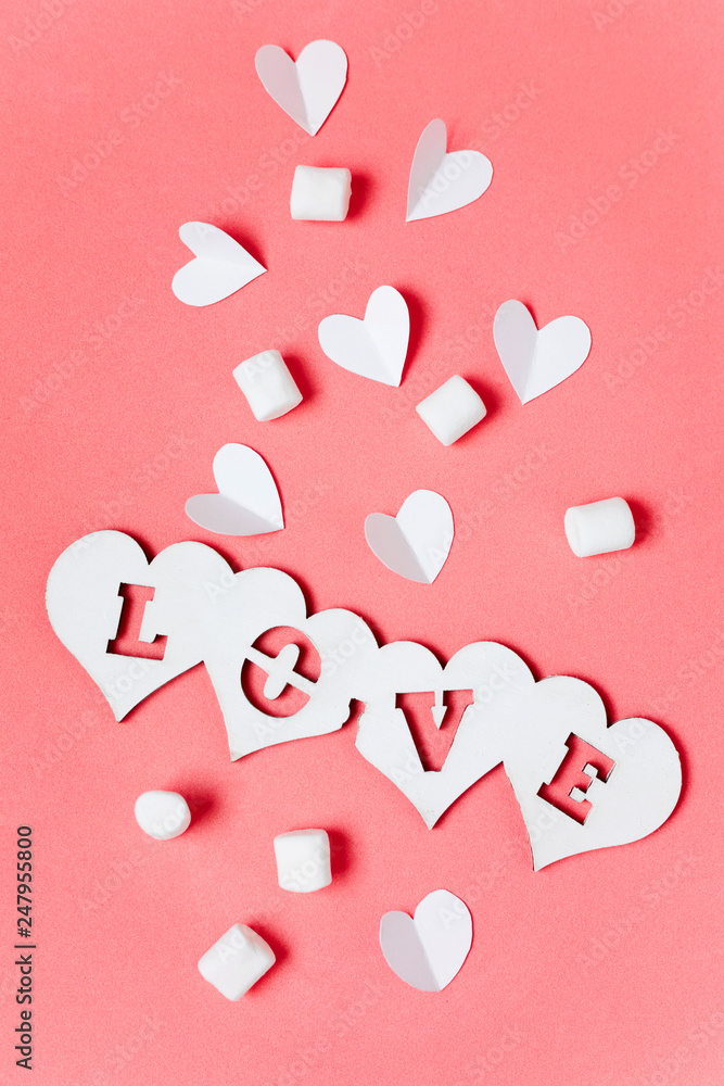 Love word and white hearts on pink background, Valentine's Day concept photo.