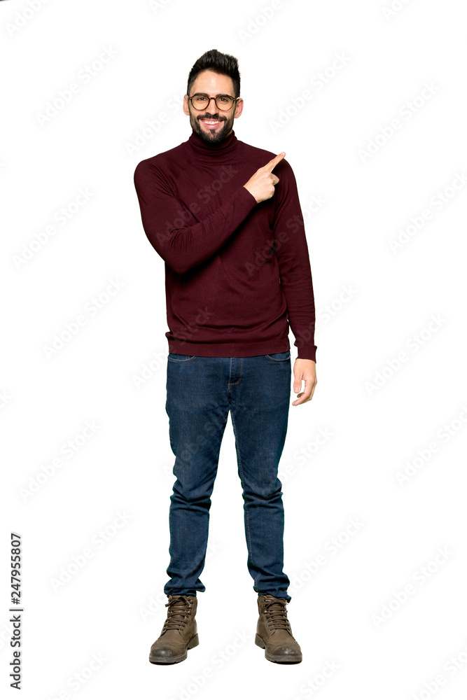 Full-length shot of Handsome man with glasses pointing to the side to present a product on isolated white background Full-length shot of Handsome man with glasses pointing to the side to present a product on isolated white background