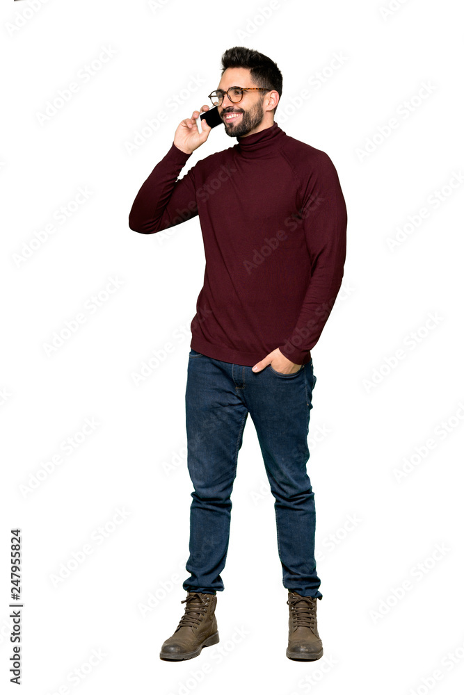 Full-length shot of Handsome man with glasses keeping a conversation with the mobile phone on isolated white background Full-length shot of Handsome man with glasses keeping a conversation with the mobile phone on isolated white background