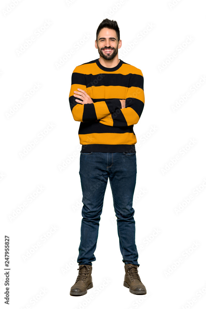 Full-length shot of Handsome man with striped sweater keeping the arms crossed in frontal position on isolated white background Full-length shot of Handsome man with striped sweater keeping the arms crossed in frontal position on isolated white background