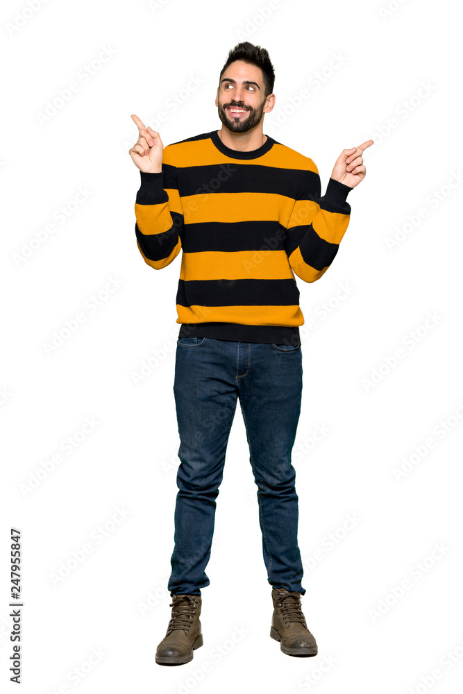 Full-length shot of Handsome man with striped sweater pointing with the index finger a great idea on isolated white background Full-length shot of Handsome man with striped sweater pointing with the index finger a great idea on isolated white background