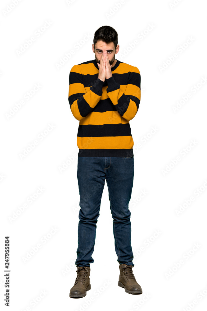 Full-length shot of Handsome man with striped sweater keeps palm together. Person asks for something on isolated white background Full-length shot of Handsome man with striped sweater keeps palm together. Person asks for something on isolated white background