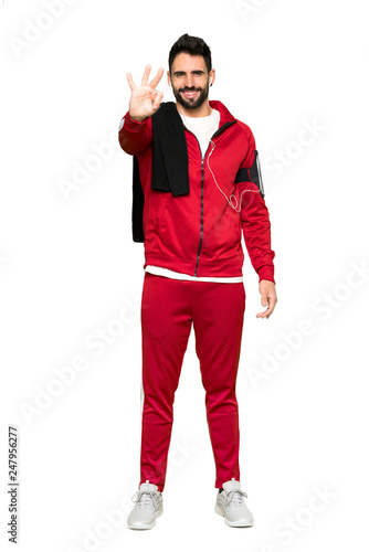 Full-length shot of Handsome sportman happy and counting three with fingers on isolated white background © luismolinero