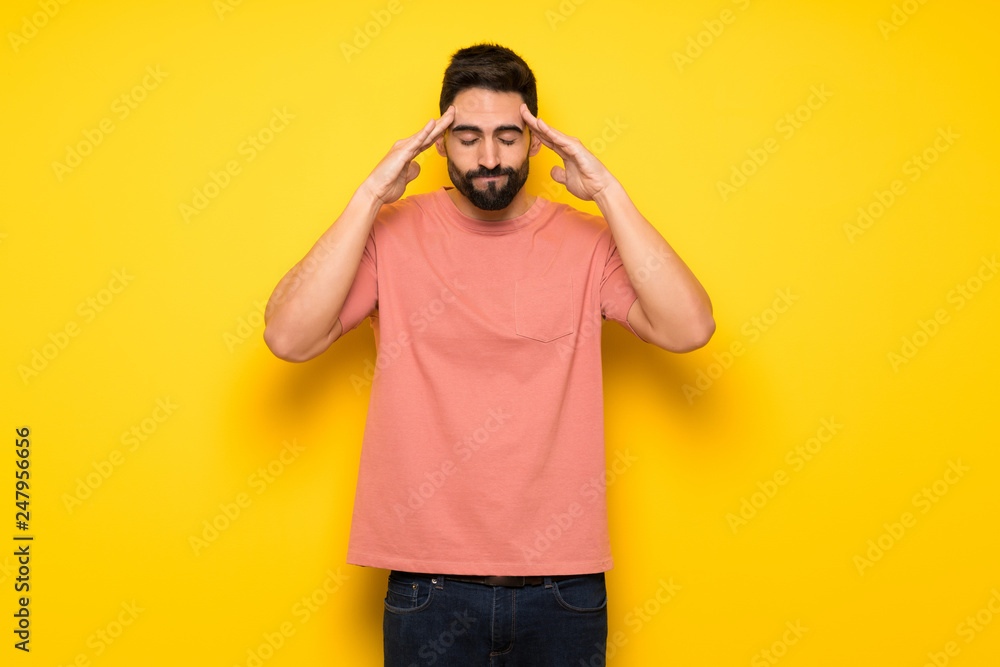 Handsome man over yellow wall unhappy and frustrated with something Handsome man over yellow wall unhappy and frustrated with something