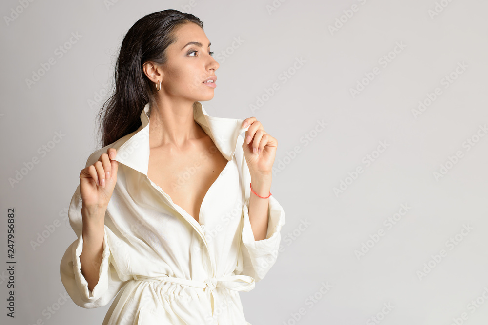Portrait of beautiful woman in white dress or bathrobe with wet style hair on white background. Place for text. Copy space Portrait of beautiful woman in white dress or bathrobe with wet style hair on white background. Place for text. Copy space