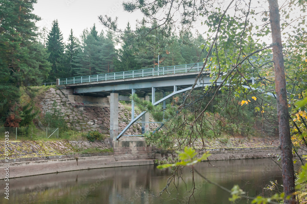 Autumn landscape of bridge and Kymijoki river waters in Finland, Kymenlaakso, Kouvola, Myllykoski.