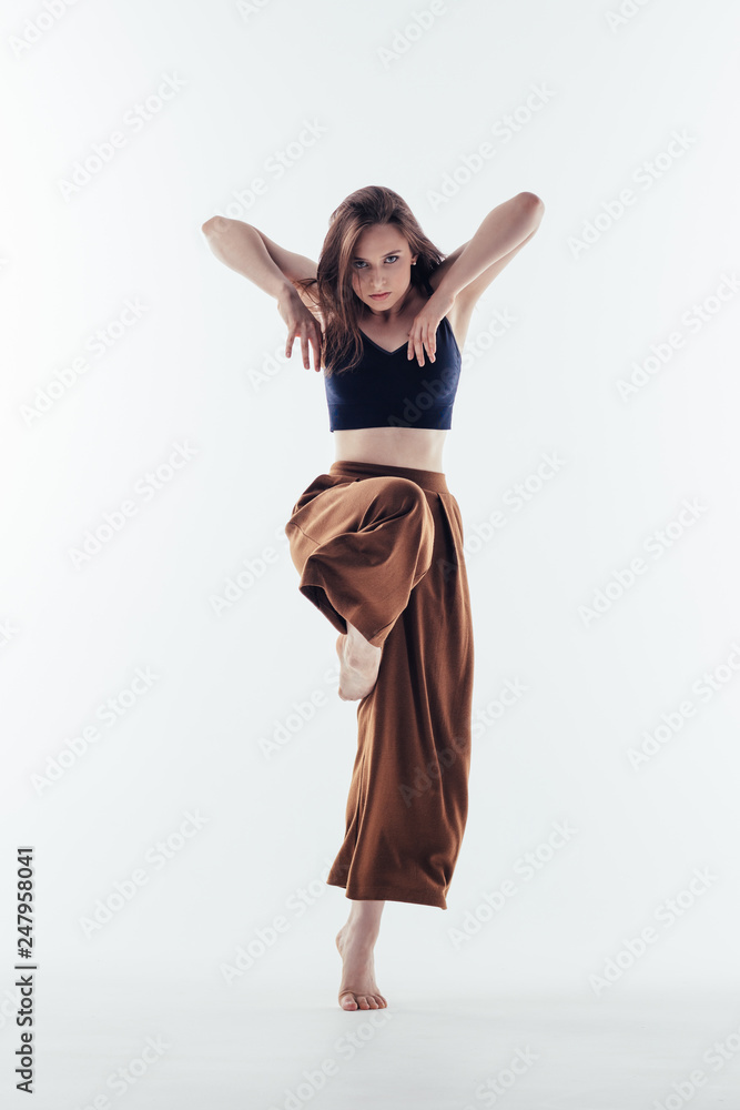 Fototapeta premium Young beautiful dancer posing in studio