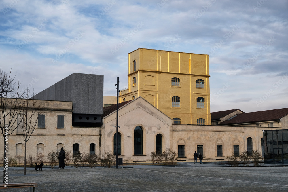 Milan, ITALY FEB 2019 - Fondzione Prada museum - golden yellow warm building in the new square Adriano Olivetti in the south of town.