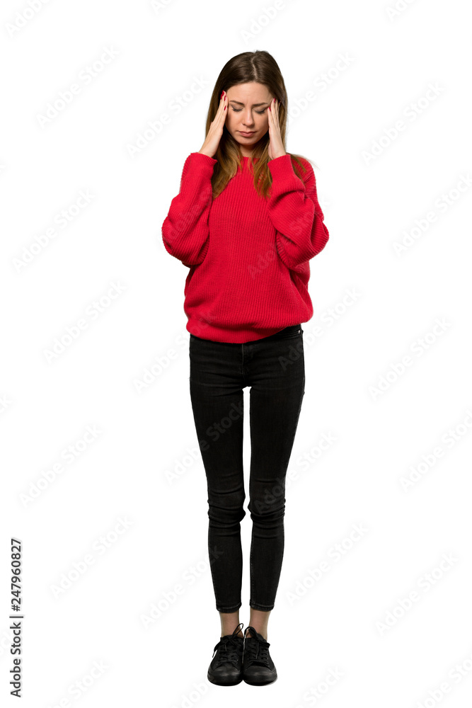 A full-length shot of a Young woman with red sweater with headache over isolated white background A full-length shot of a Young woman with red sweater with headache over isolated white background