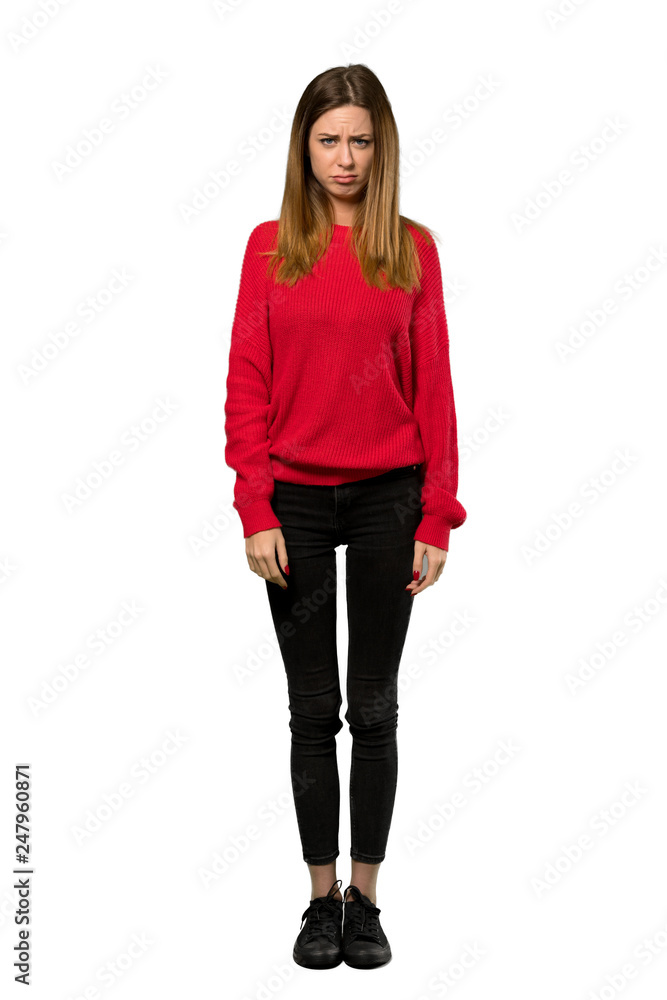 A full-length shot of a Young woman with red sweater with sad and depressed expression over isolated white background A full-length shot of a Young woman with red sweater with sad and depressed expression over isolated white background