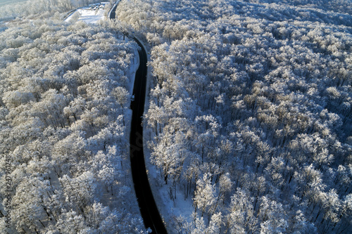 aerial drone view with road and winter forest