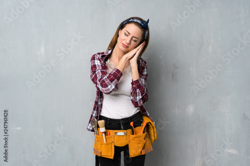Craftsmen or electrician woman making sleep gesture in dorable expression