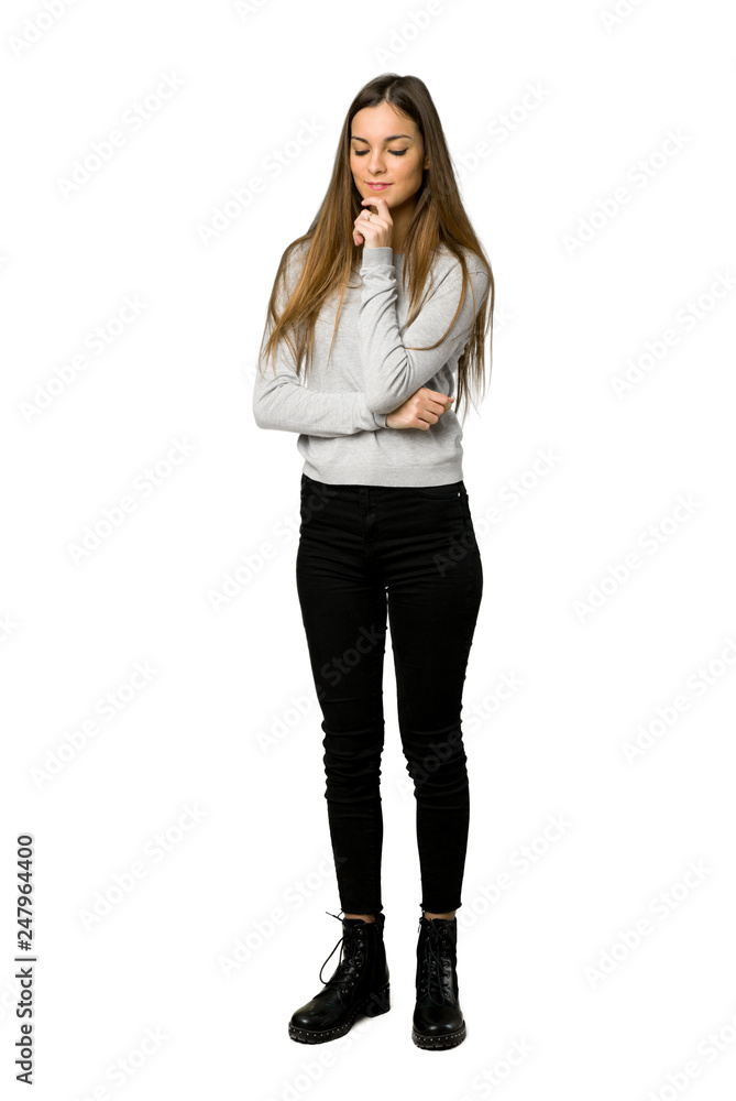 Full-length shot of young girl looking down with the hand on the chin on isolated white background Full-length shot of young girl looking down with the hand on the chin on isolated white background