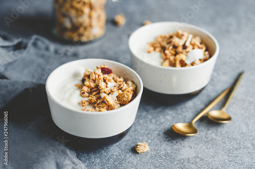 Breakfast bowls with organic granola, nuts, coconut chips and greek yoghurt.