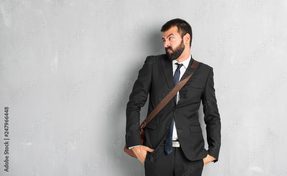 Businessman with beard is a little bit nervous and scared pressing the teeth Businessman with beard is a little bit nervous and scared pressing the teeth