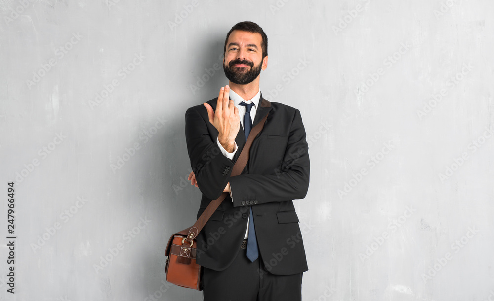 Businessman with beard inviting to come with hand. Happy that you came Businessman with beard inviting to come with hand. Happy that you came
