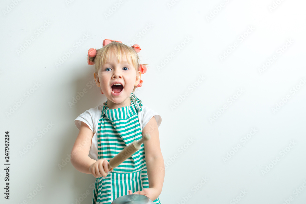 toddler in role of crasy andgry housewife with frying pan and pink curlers toddler in role of crasy andgry housewife with frying pan and pink curlers