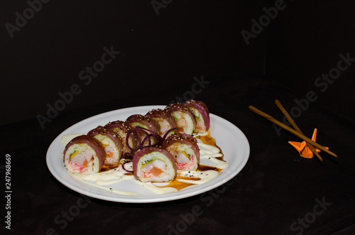 Sushi rolls in white plate and dark background