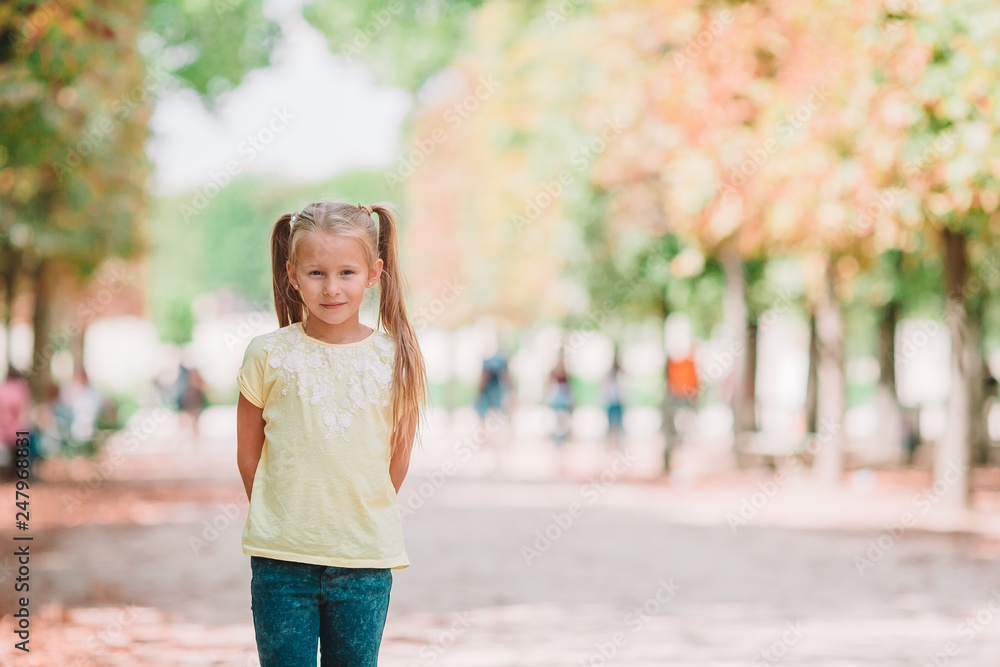Adorable fashion little girl outdoors in the Tuileries Gardens, Paris