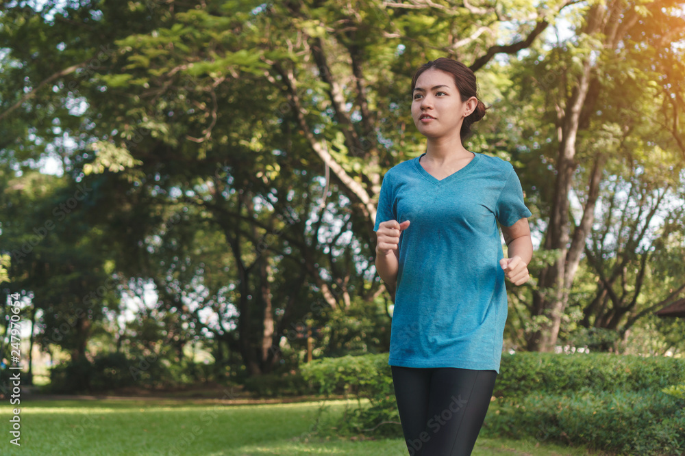 Young asian runner woman running in the park in sportswear morning time, Exercise and healthy concept, Selective focus. Young asian runner woman running in the park in sportswear morning time, Exercise and healthy concept, Selective focus.