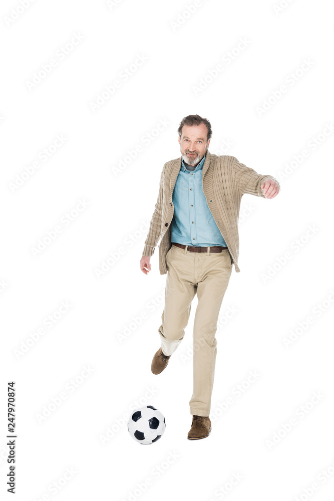 Naklejka premium smiling senior man playing football isolated on white