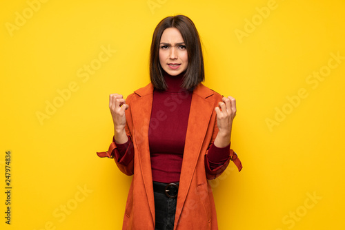 Young woman with coat frustrated by a bad situation © luismolinero
